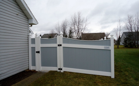 Gray vinyl Lakeland-style concave fence