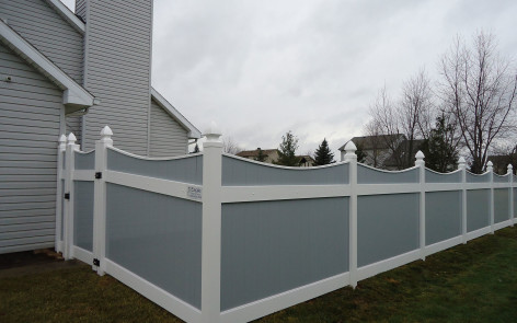 Gray vinyl Lakeland-style concave fence
